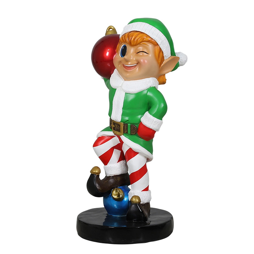 Elf holding ornament ball