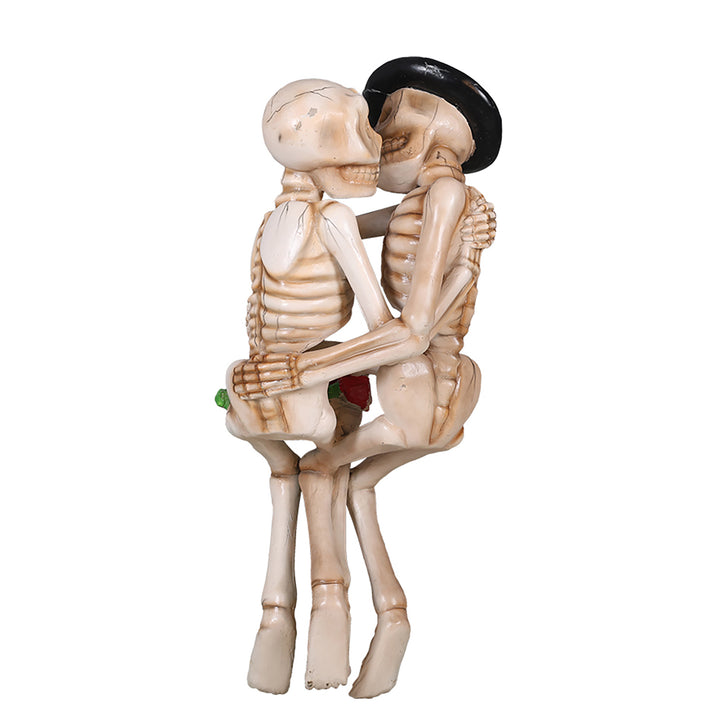 two skeletons kissing on a bench back view